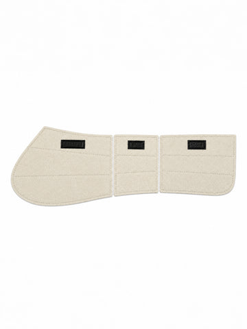 Three interchangeable cream felt saddle pad inserts featuring stitched panels and thickness labels.