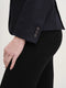 Close-up of a navy merino wool riding jacket sleeve featuring three detailed corozo buttons on the cuff.