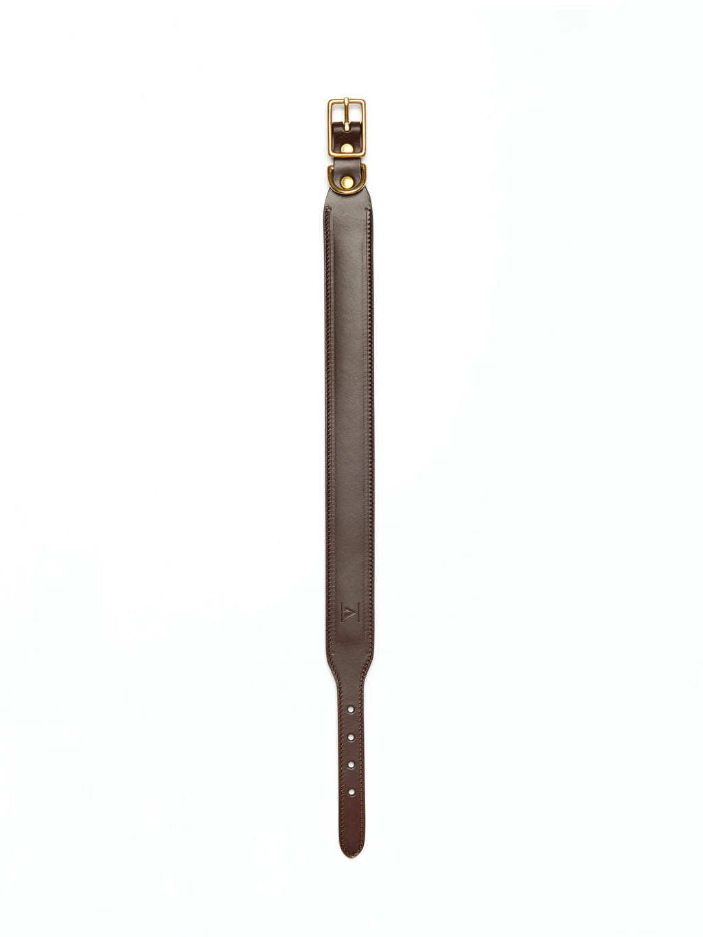 A wide dark brown stitched leather dog collar from Manifattura VALOR laid flat vertically, featuring a subtly embossed V shield monogram logo and a brass roller buckle.