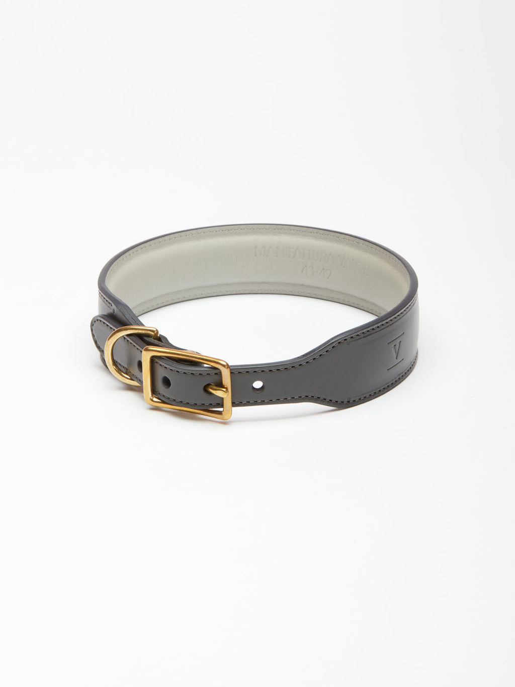 A wide slate grey leather dog collar from Manifattura VALOR featuring a light grey padded lining, a solid brass roller buckle, and a subtly embossed V shield monogram logo.