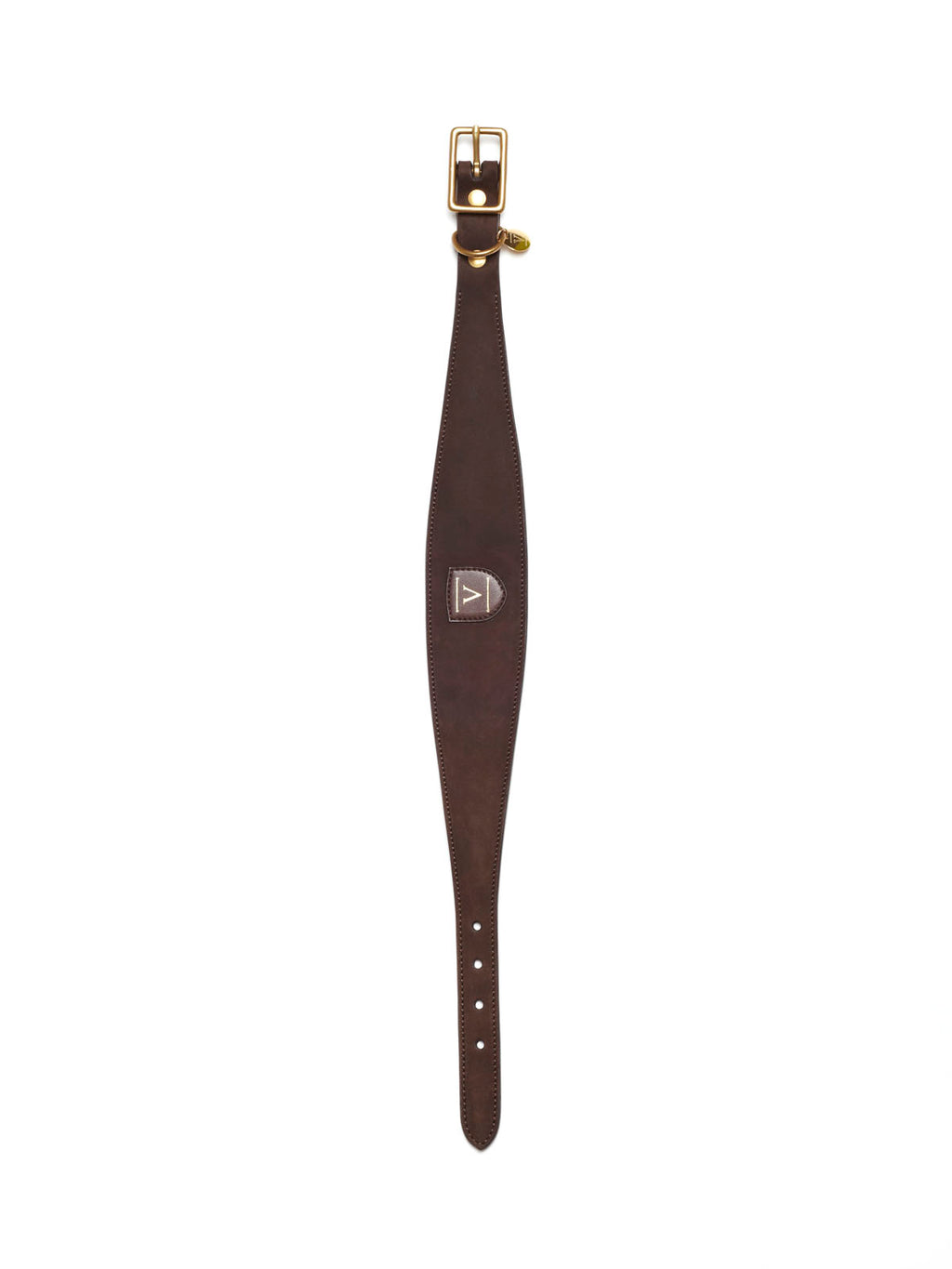 A wide dark brown nubuck leather dog collar from Manifattura VALOR laid flat vertically, featuring an ergonomic tapered design, a gold-embossed shield logo patch, and a brass roller buckle.