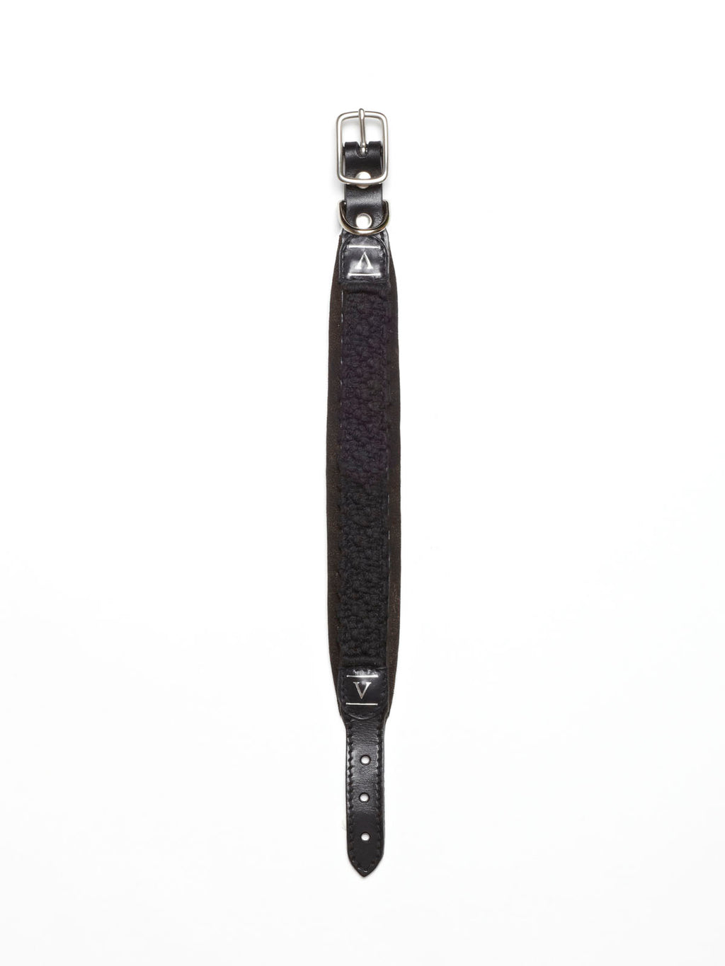 A black hand-knotted macramé rope dog collar from Manifattura VALOR featuring dark brown leather details, a silver roller buckle, and white stitched triangular accents.