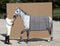 Woman in equestrian attire with a dapple grey horse wearing a grey wool blanket in an outdoor arena.