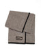A folded brown and beige herringbone wool blanket featuring a black suede border and a Valor leather patch.
