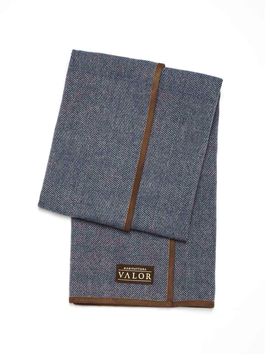 Folded blue herringbone wool horse blanket with brown trim and VALOR brand patch.