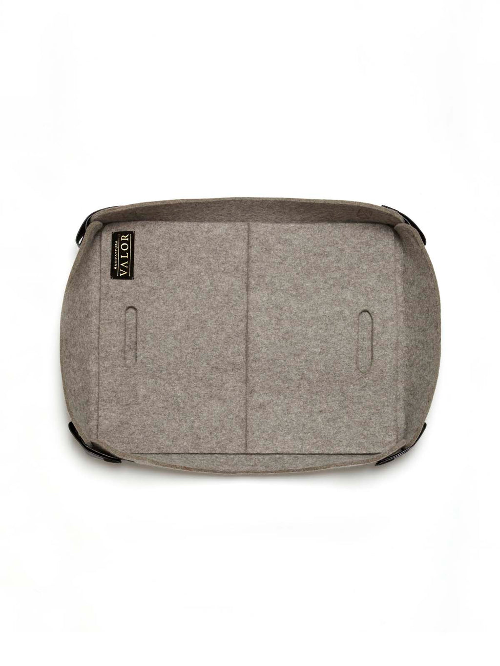 Top view of Manifattura Valor rollable dog bed in grey wool felt, showing brand label and leather side straps.
