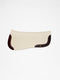 A side-view image of a cream-colored felt horse saddle pad with dark mahogany leather wear leathers and a small logo, isolated on a white background.