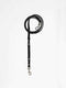 A black leather dog lead from Manifattura VALOR featuring a black hand-knotted macramé accent section, silver-tone swivel snap hooks, and white stitched triangular details.